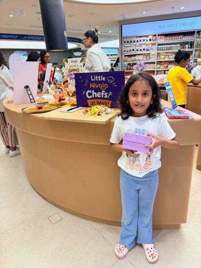 A little chef with her packed box of modaks